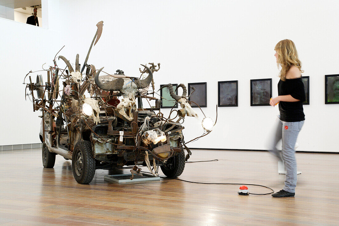 Young woman looking at a sculpture in the Jean Tinguely Museum, Basel, Switzerland