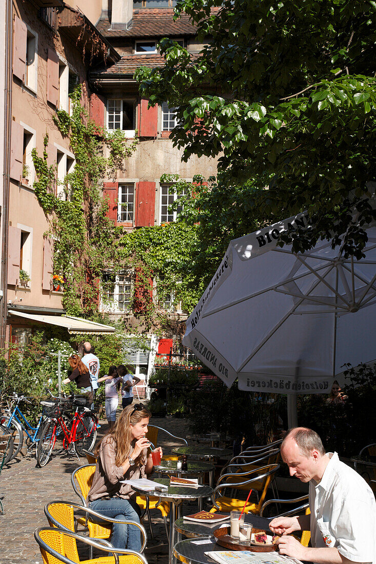 People sitting in a cafe at Andreasplatz, Basel, Switzerland