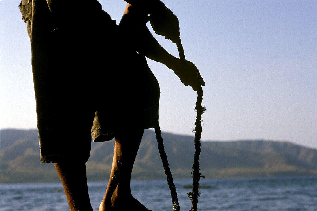 Silhoutte of a man pulling a rope