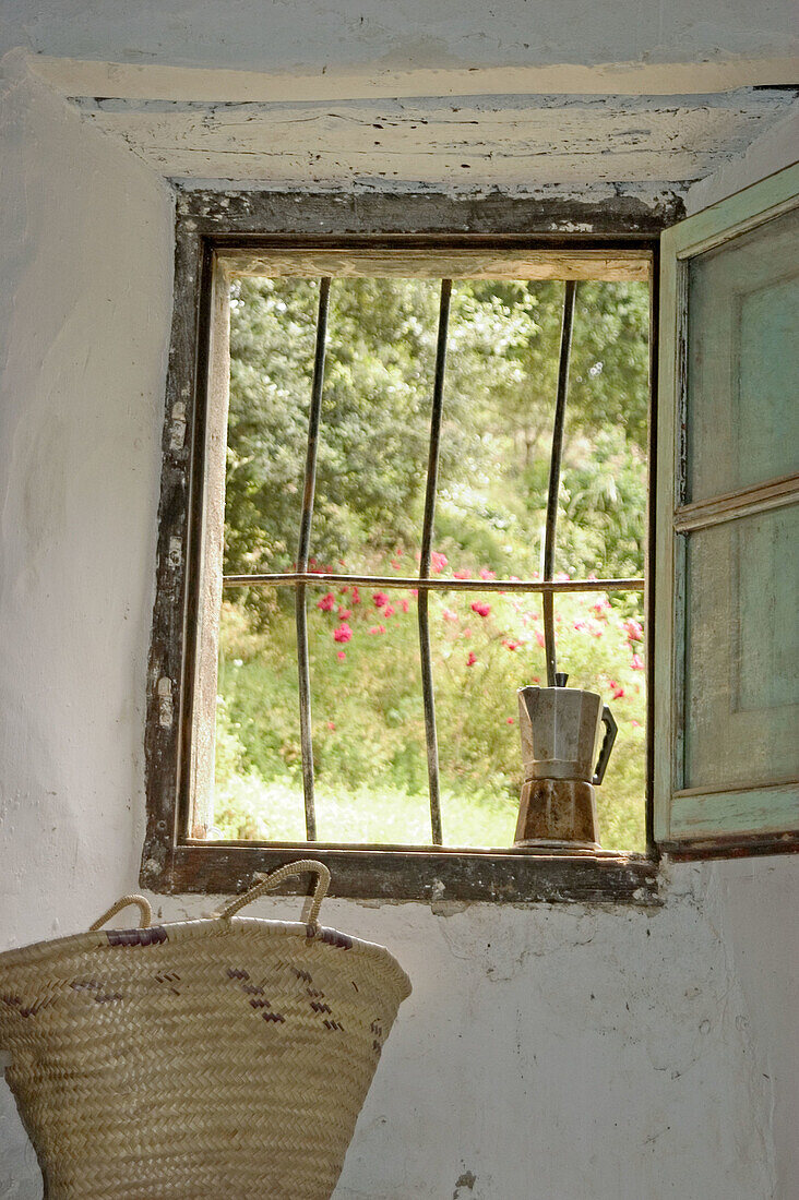 Window in country house with coffee maker and basket