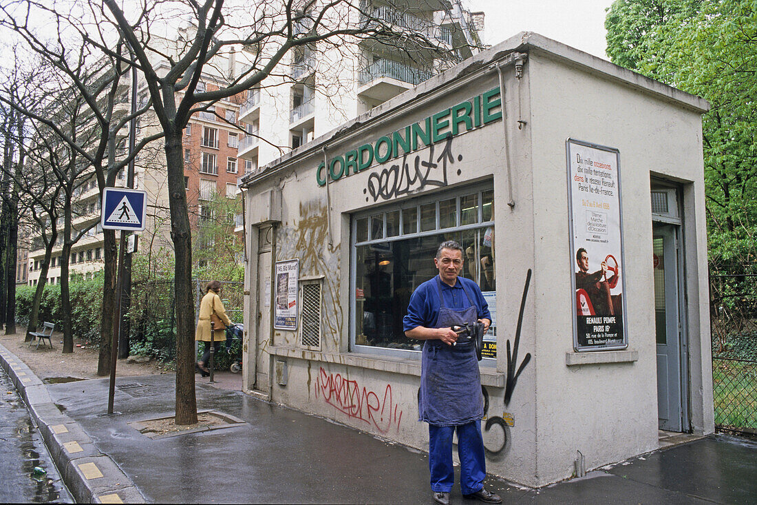 Shoemaker outside his shop, Cordonnerie, Paris, France