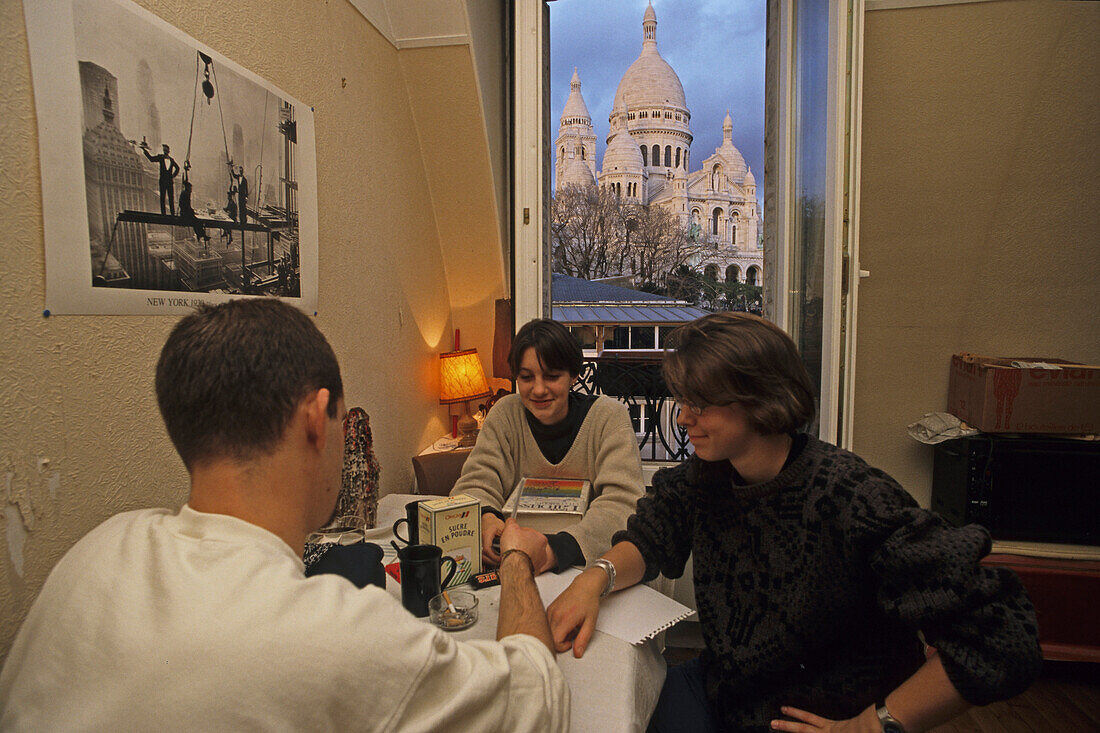 Students in an attic flat, apartment with view of the Sacre Coeur, Paris, France