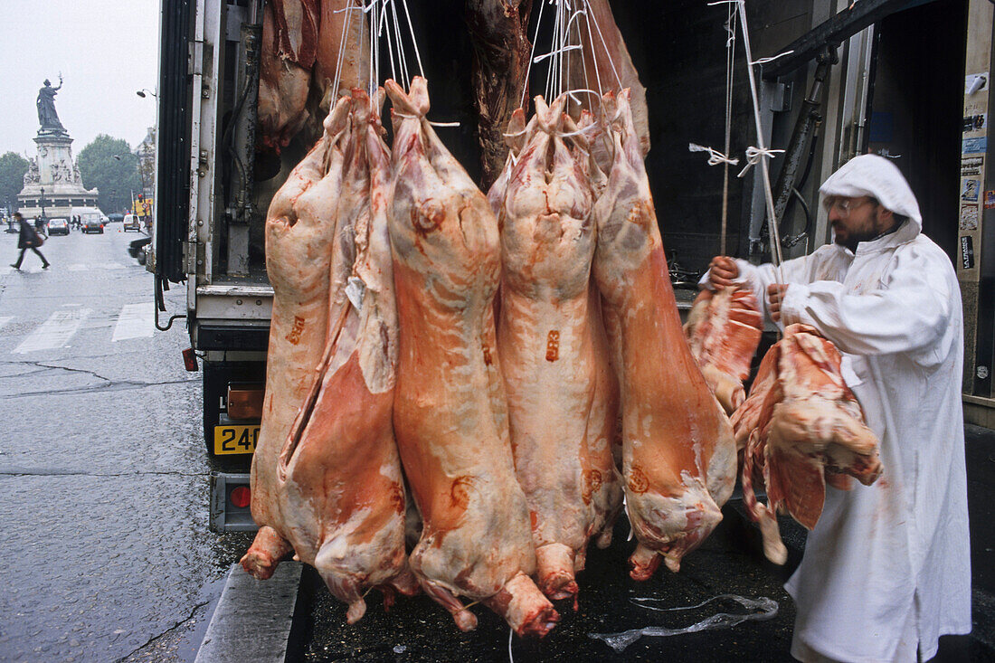 Man delivering meat to a butcher, Butchers shop, Paris, France