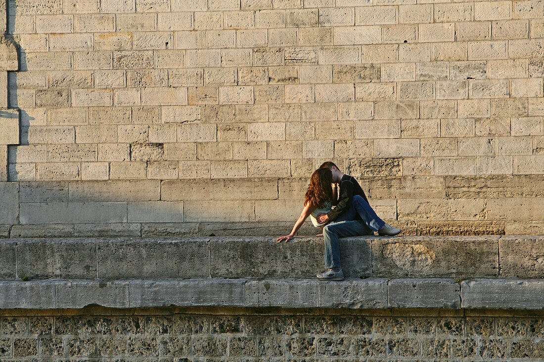 Young couple kissing on the quay wall of the Seine, Paris, France, Europe