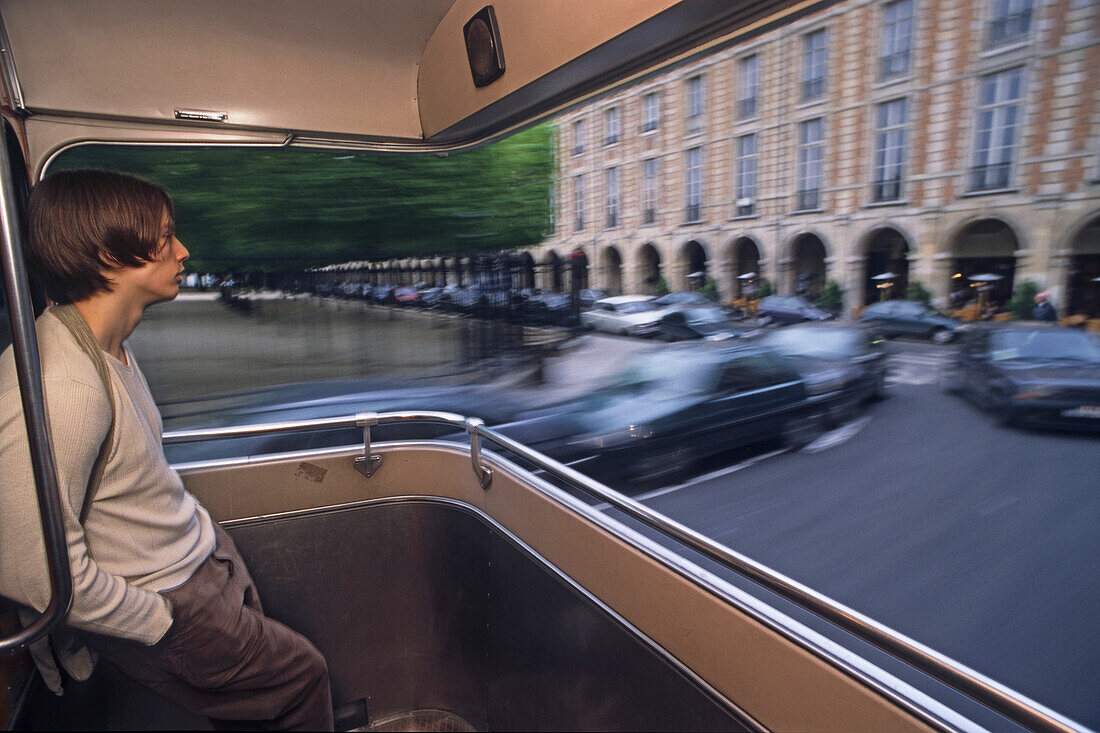 Passenger on open platform of public bus, Place des Vosges, Paris, France, Europe