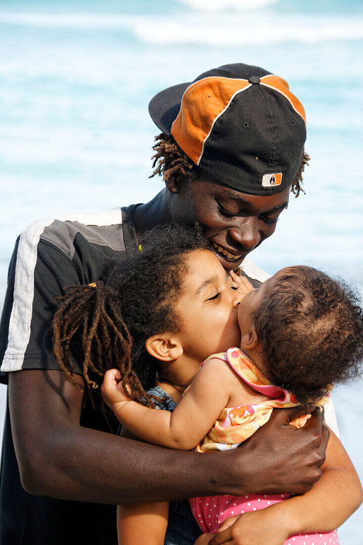 Jamaica Boston bay Jamaican father with kids kissing each other