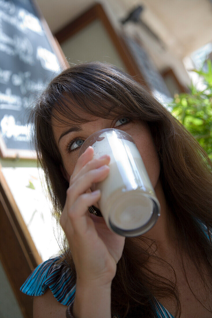 Junge Frau genießt Café Latte im Café Soller, Soller, Mallorca, Balearen, Spanien, Europa