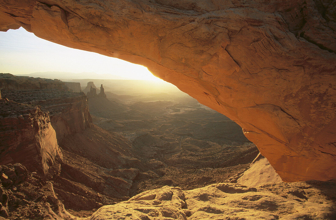 Washer Woman Arch seen through Mesa Arch at sunrise. Island in the Sky district. Canyonlands National Park. Utah. USA