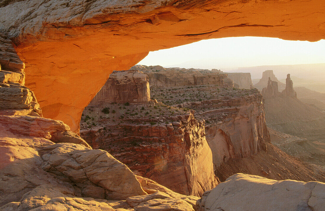 Washer Woman Arch seen through Mesa Arch at sunrise. Canyonlands National Park. Utah. USA.