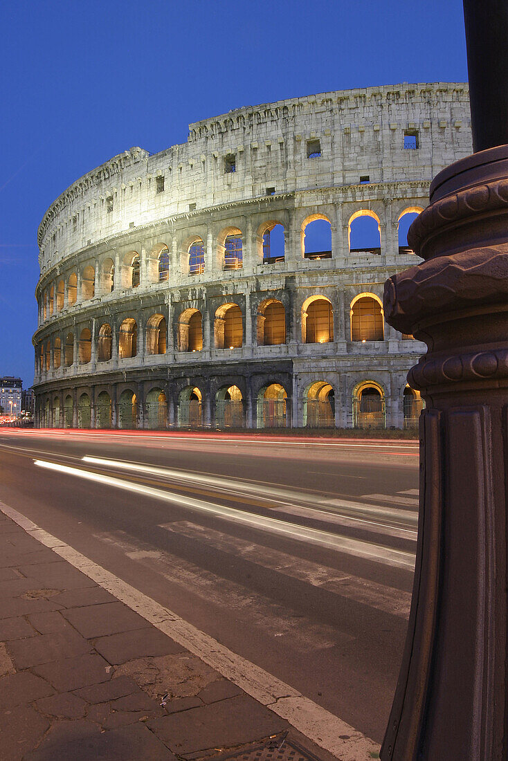 Via dei Fori Imperiali. Night view of the Colosseum in Rome. Italy