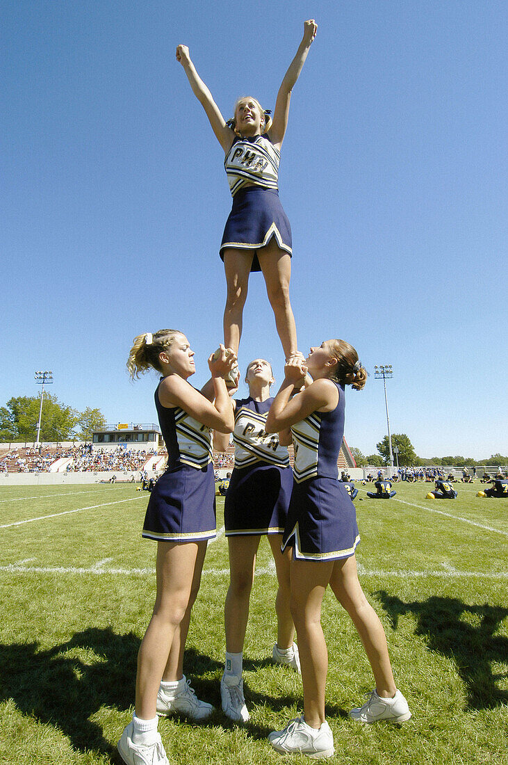 Cheerleads perform during high school football game