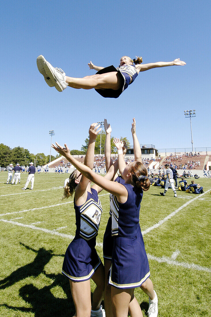 Cheerleaders performing during football game