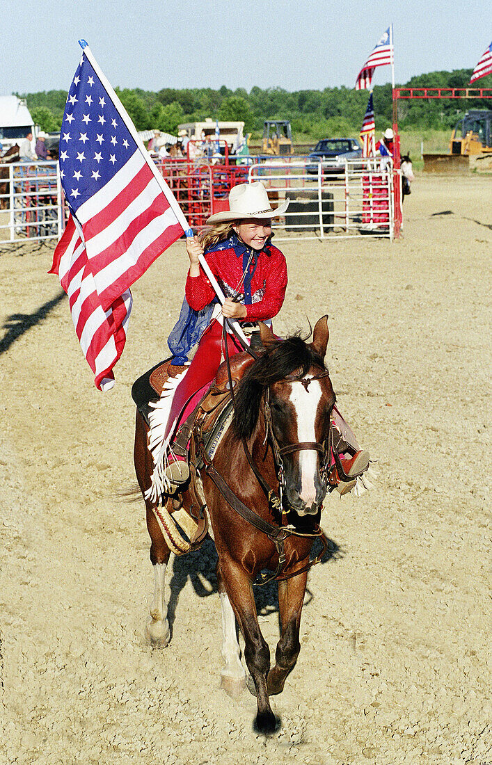 Teen female flag bearer in opening ceremonies of rodeo