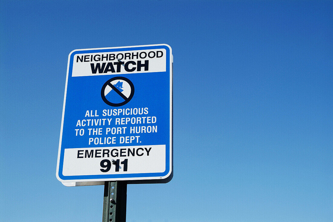 Neighborhood watch sign advises suspicious activity to be reported to 911 police