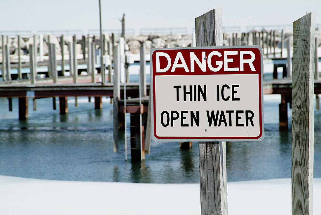 Sign indicating danger thin ice and open water