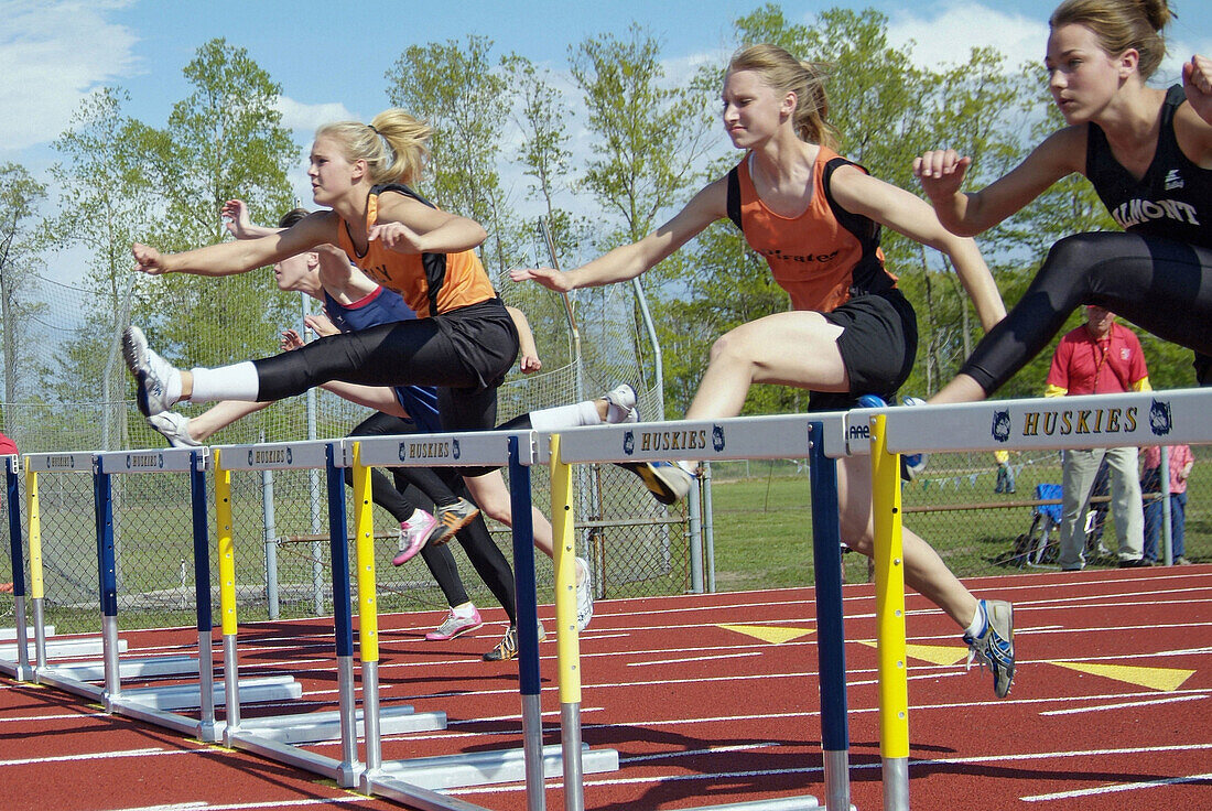 High School Track and Field event: jumping the hurdles