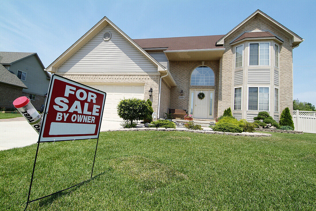 Residential home with for sale by owner sign