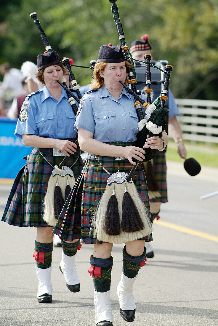 Portrait of Bag pipers playing music as they march in a parade