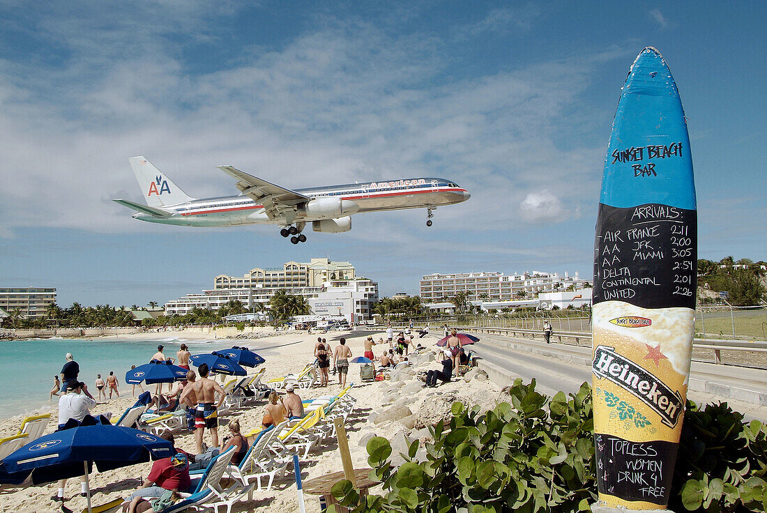 Air planes land at runway which ends at the Sun Beach on the caribbean Island of St. Maarten Martin in the West Indies