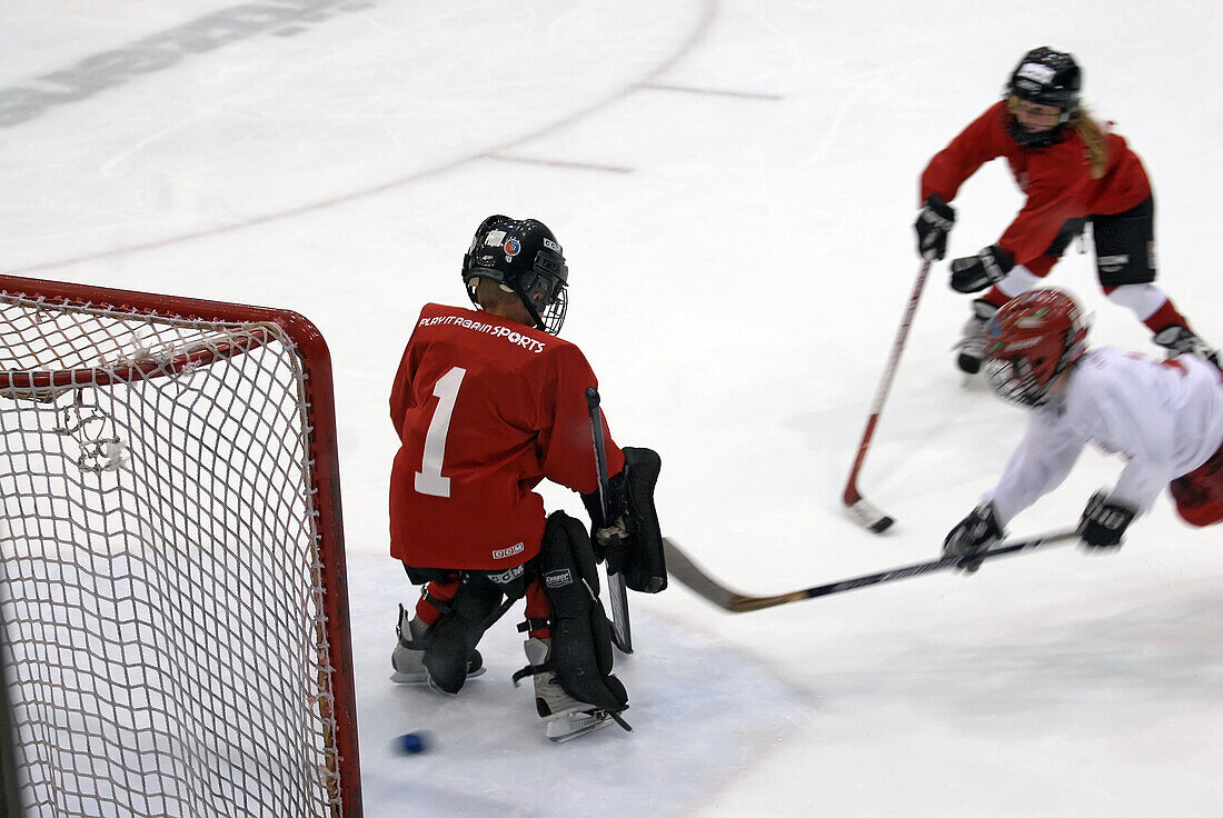 6 year old boy plays the position of golie in a juvenile ice hockey program