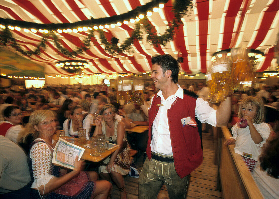 Waiter carrying large beer steins, Gauboden Festival, Straubing, Lower Bavaria, Germany