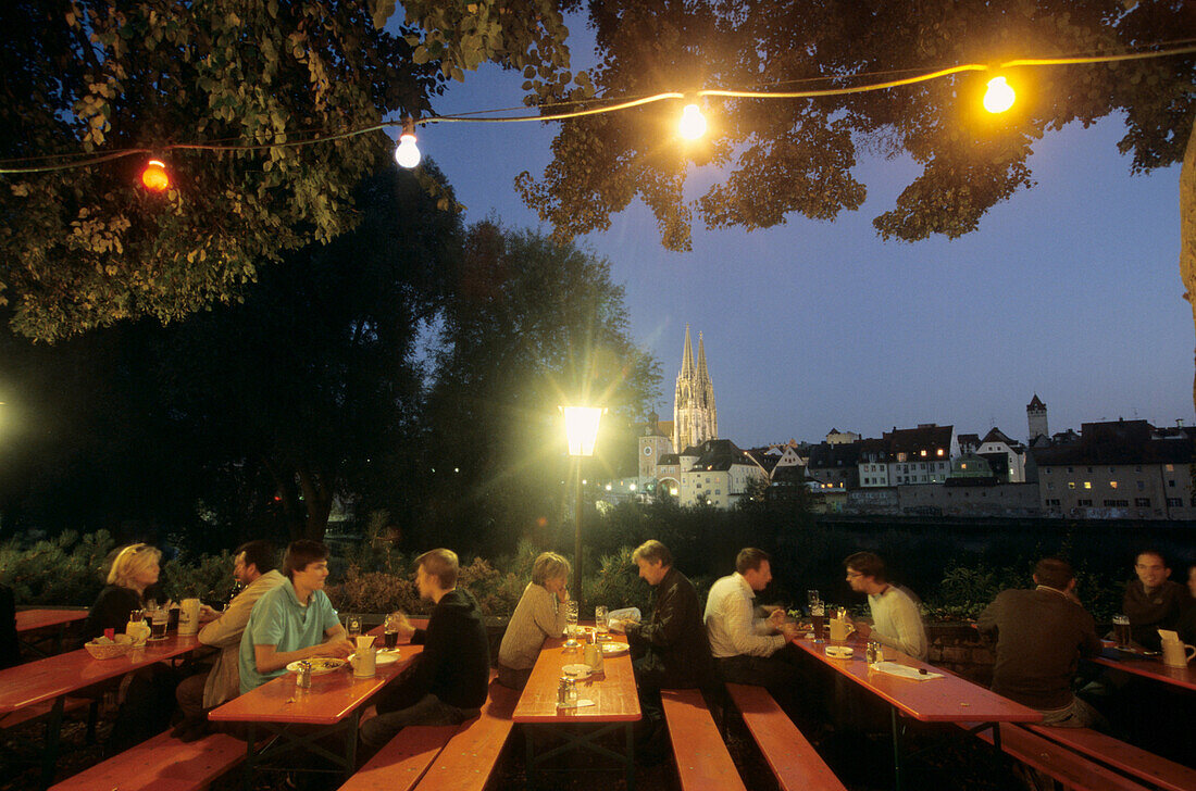 Guests in a beergarden, cathedral in background, Regensburg, Bavaria, Germany