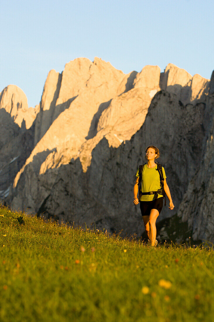 Woman hiking over Zwiesel Alp, Gosau Ridge, Upper Austria, Austria