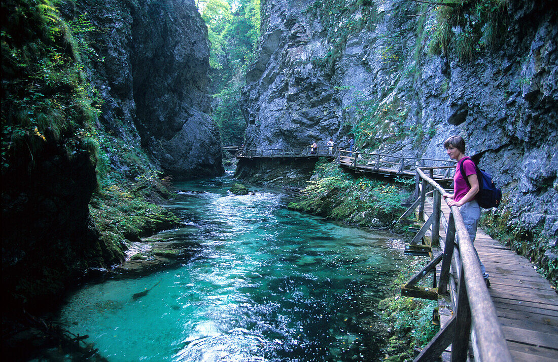 Woman walking through Vintar Gorge in Triglav National Park, Slovenia