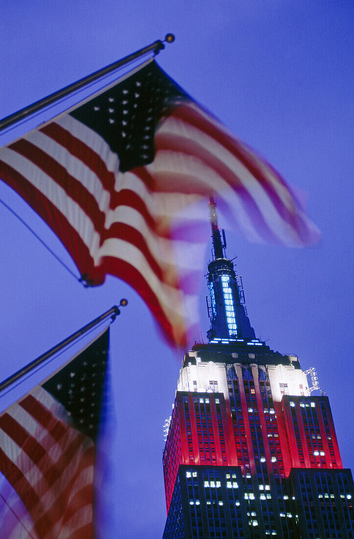 American flags and Empire State Building. New York City, USA