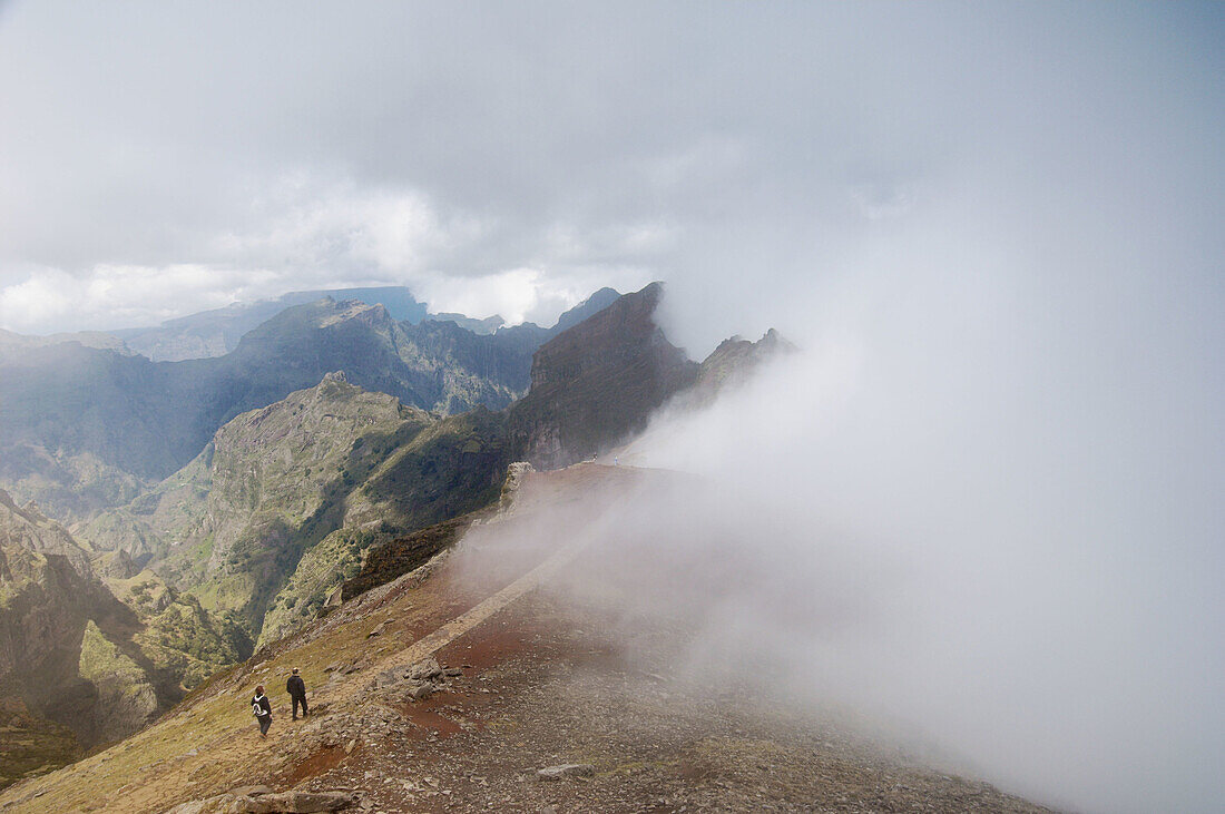 Highest area of Central Madeira Island, Portugal: volcano Pico Ruivo (1862 m) viewed from the Pico do Arieiro, showing also common Atlantic fog in the north slopes