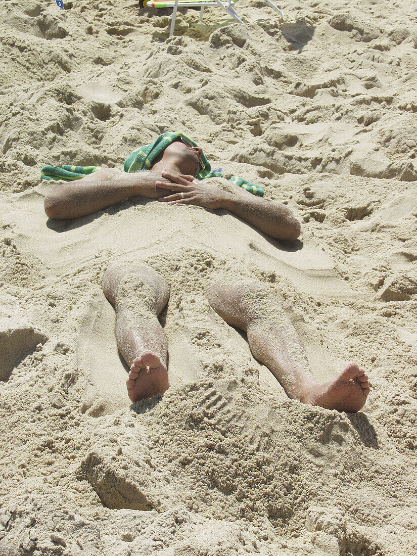 Man buried in sand