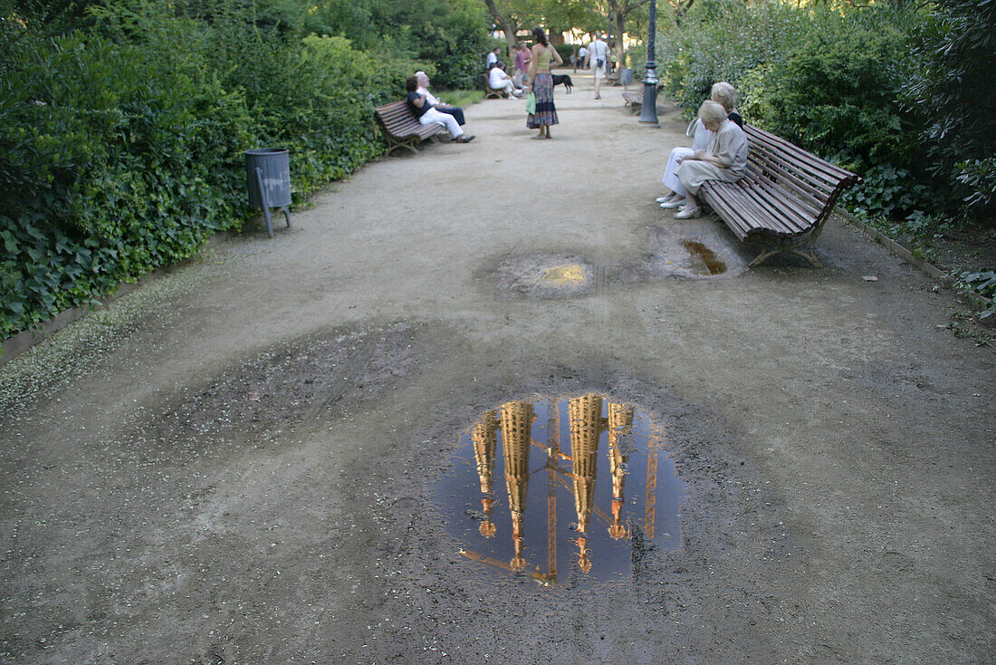 Sagrada Familia by Gaudí reflected on puddle. Sagrada Familia Square. Barcelona. Catalonia. Spain