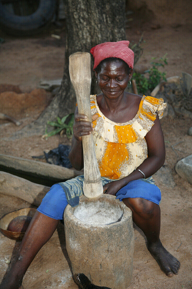 Old Lobi woman grinding millet, Gaoua area. Lobi Country, Burkina Faso
