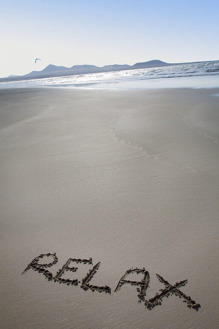 Relax message in the sand, Famara beach. Lanzarote, Canary Islands, Spain