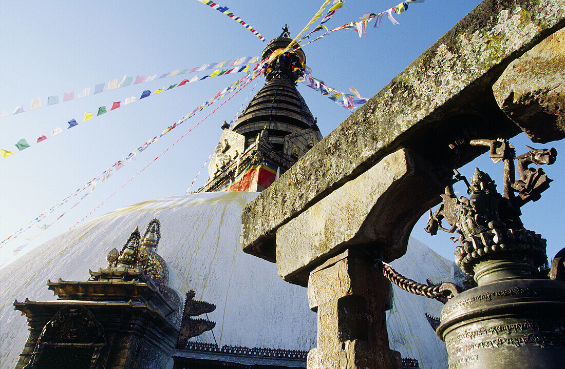 The eyes of Budda on Svayambunath called Monkey Temple and large bell, Kathmandu, Nepal.