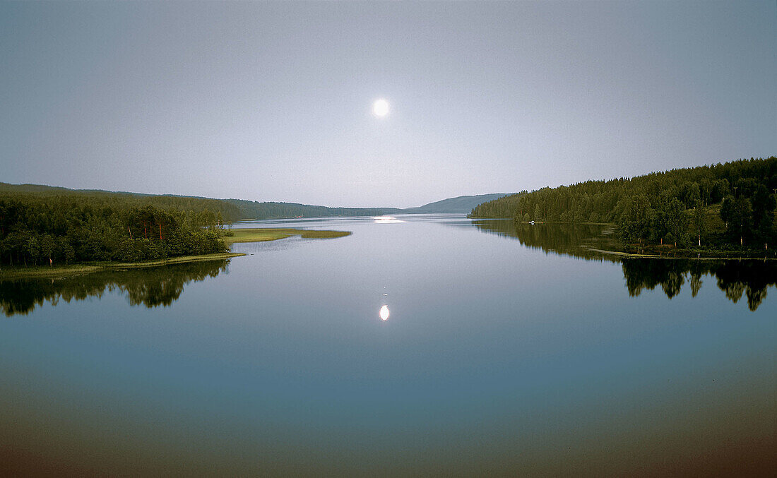 Lake and moon in a summer night. Värmland. Sweden.