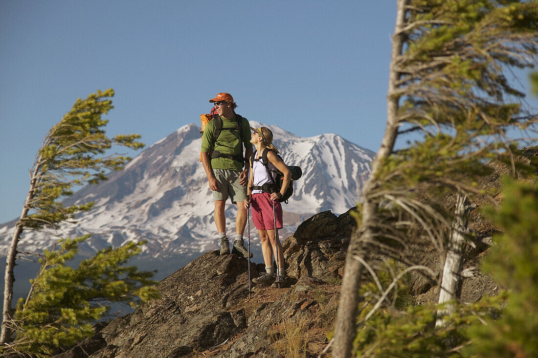A couple take a break while hiking near Mount Adams. Washington. USA