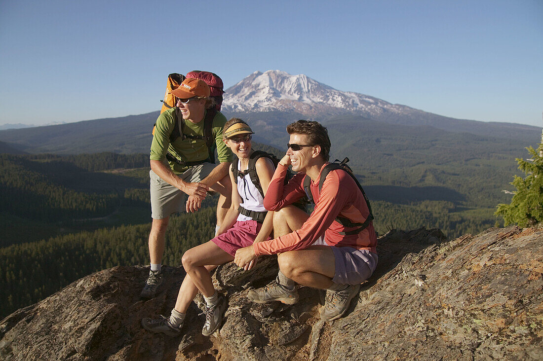 Three friends take a break while hiking near Mount Adams. Washington. USA