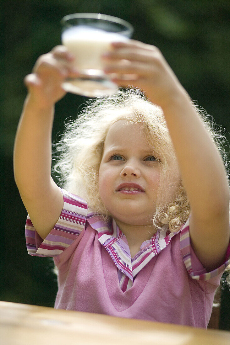 Little girl drinking glass of milk