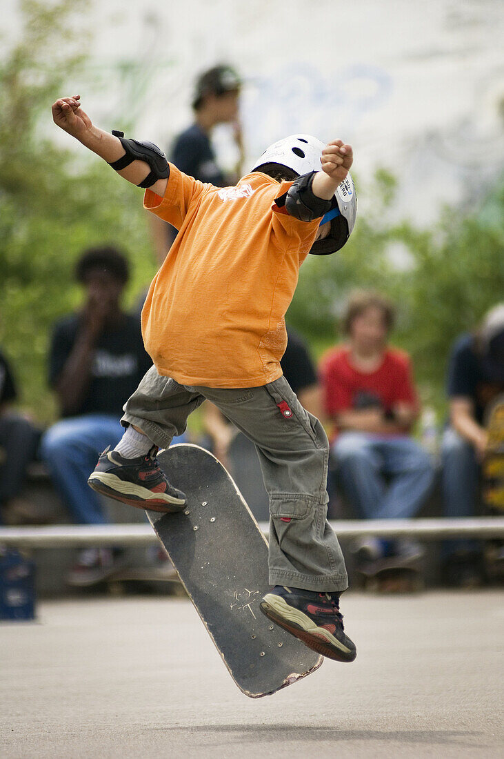 Young boy practicing skateboard skills at a local park.