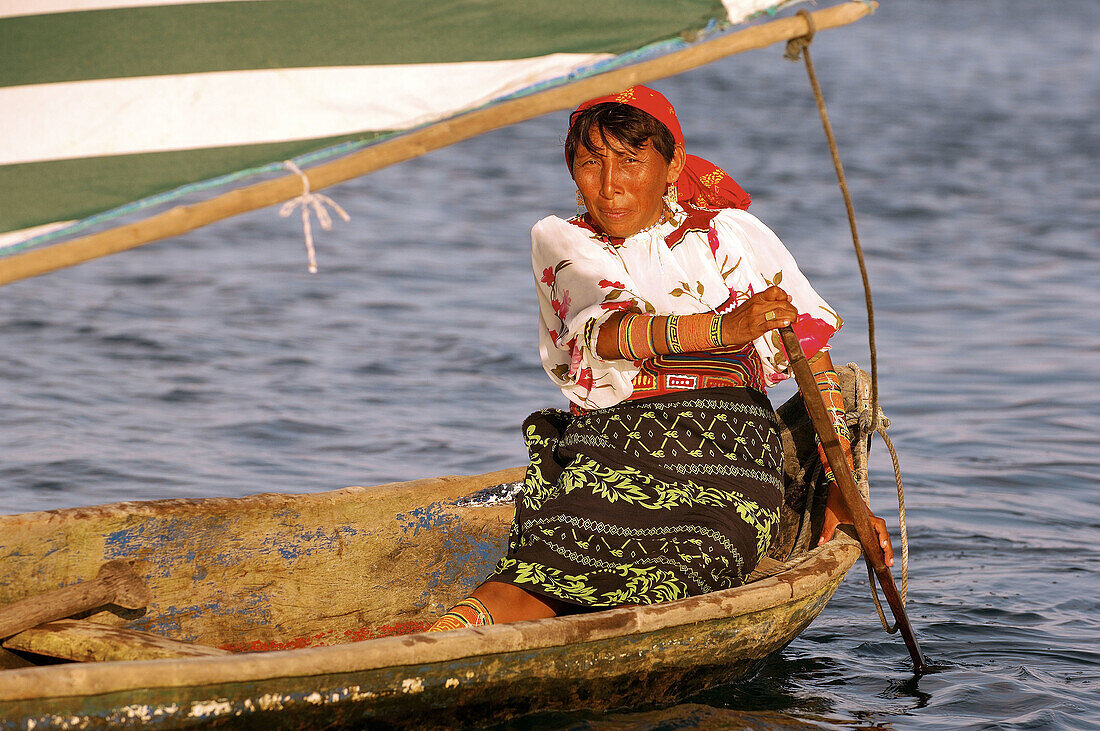 Kuna Woman sailing in a Cayuco, (litte boat). San Blas Islands, Panama.