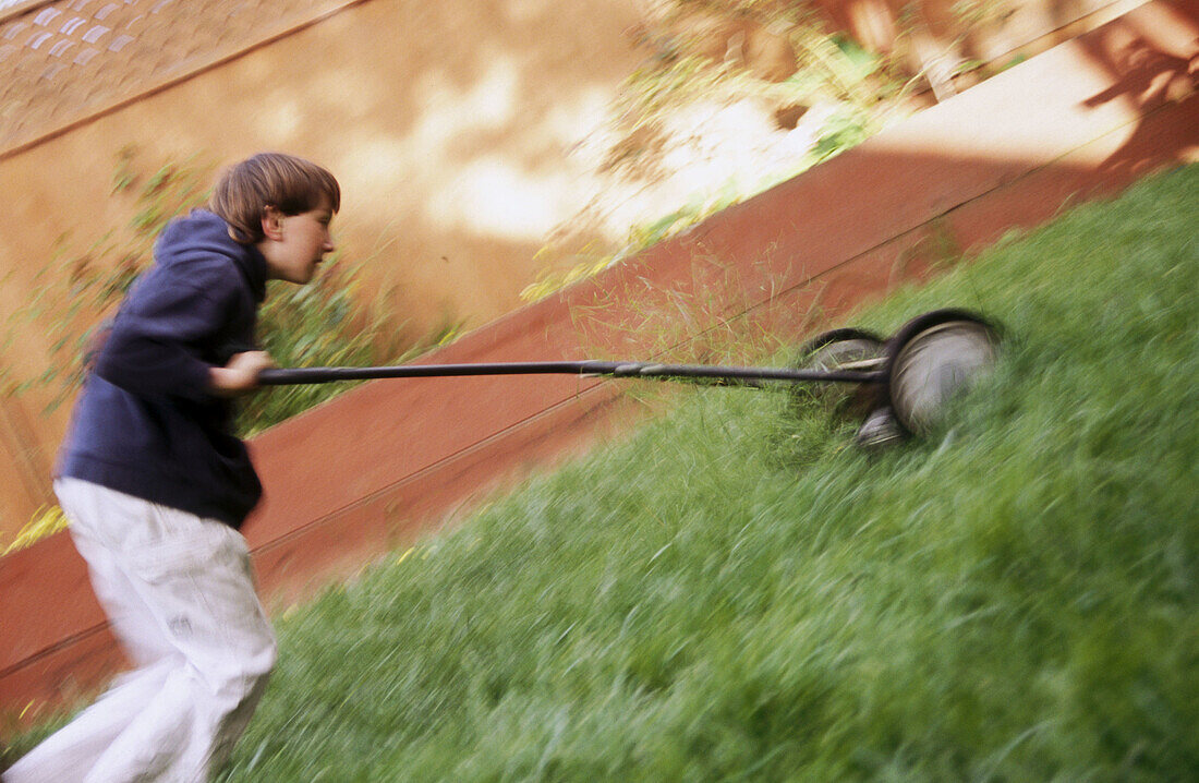 Boy, uphill mowing