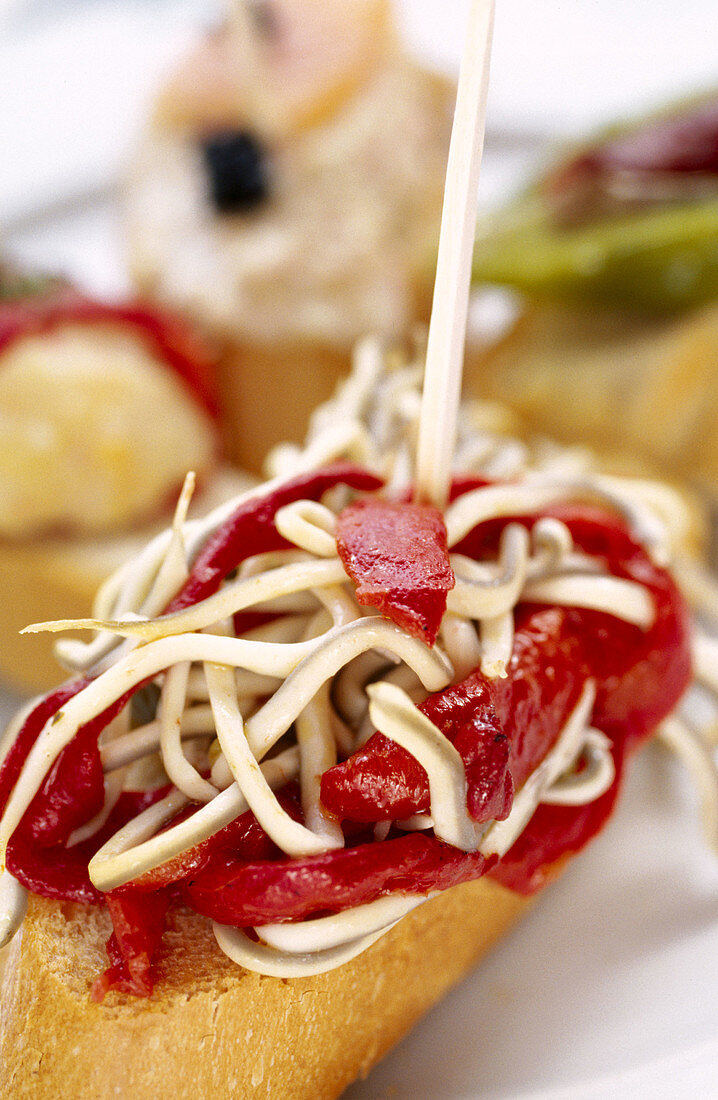 Tapa: montadito o pincho de gulas y piquillos / Tapa: succedaneous of eel and Piquillo peppers