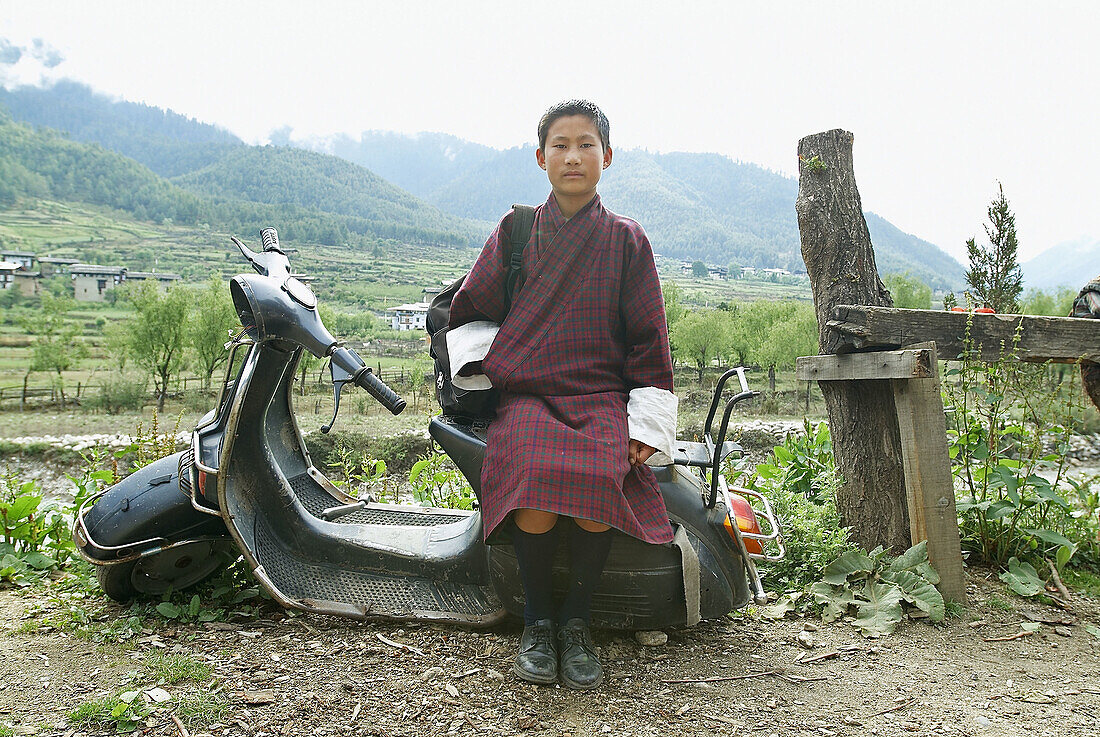 School boy, Haa, Bhutan, sitting on a scooter