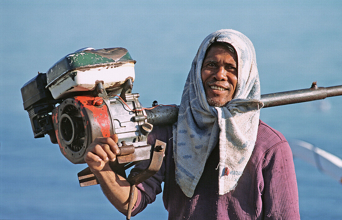 Fisherman with his boat engine. Bali, Indonesia