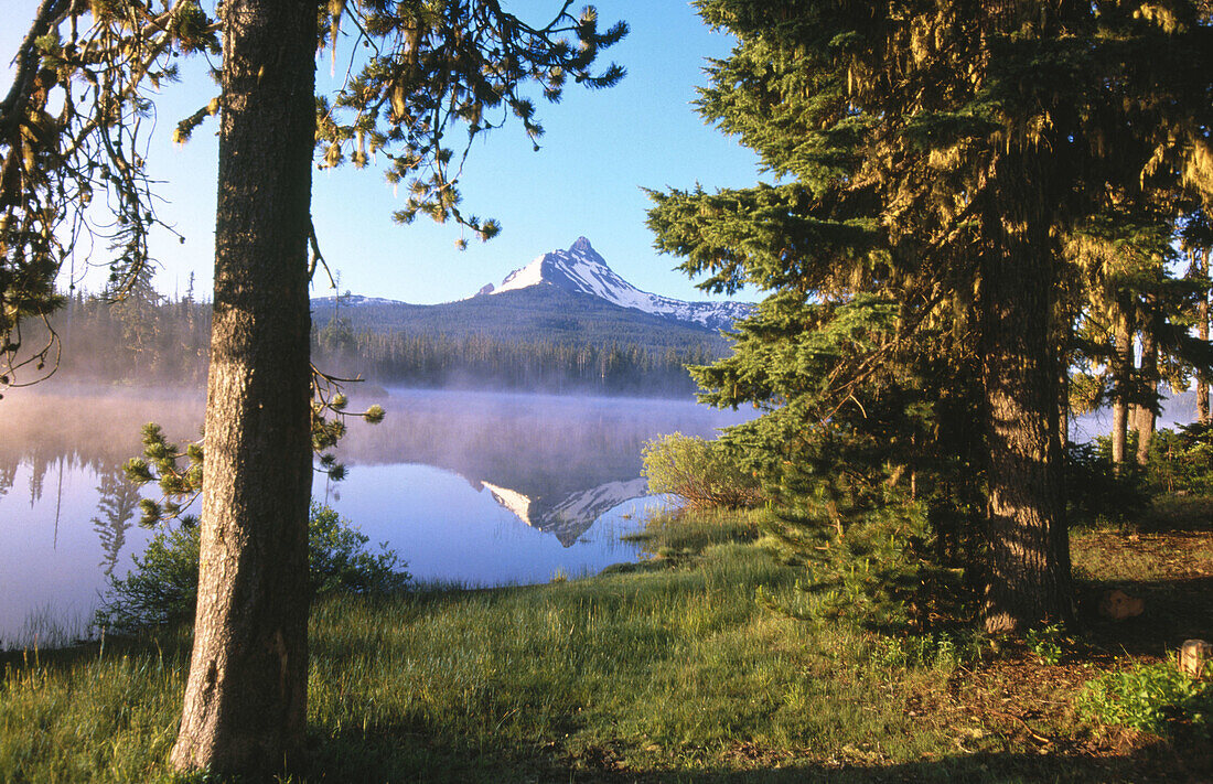 Sunrise through fog, Big Lake, Mount Washington. Oregon, USA