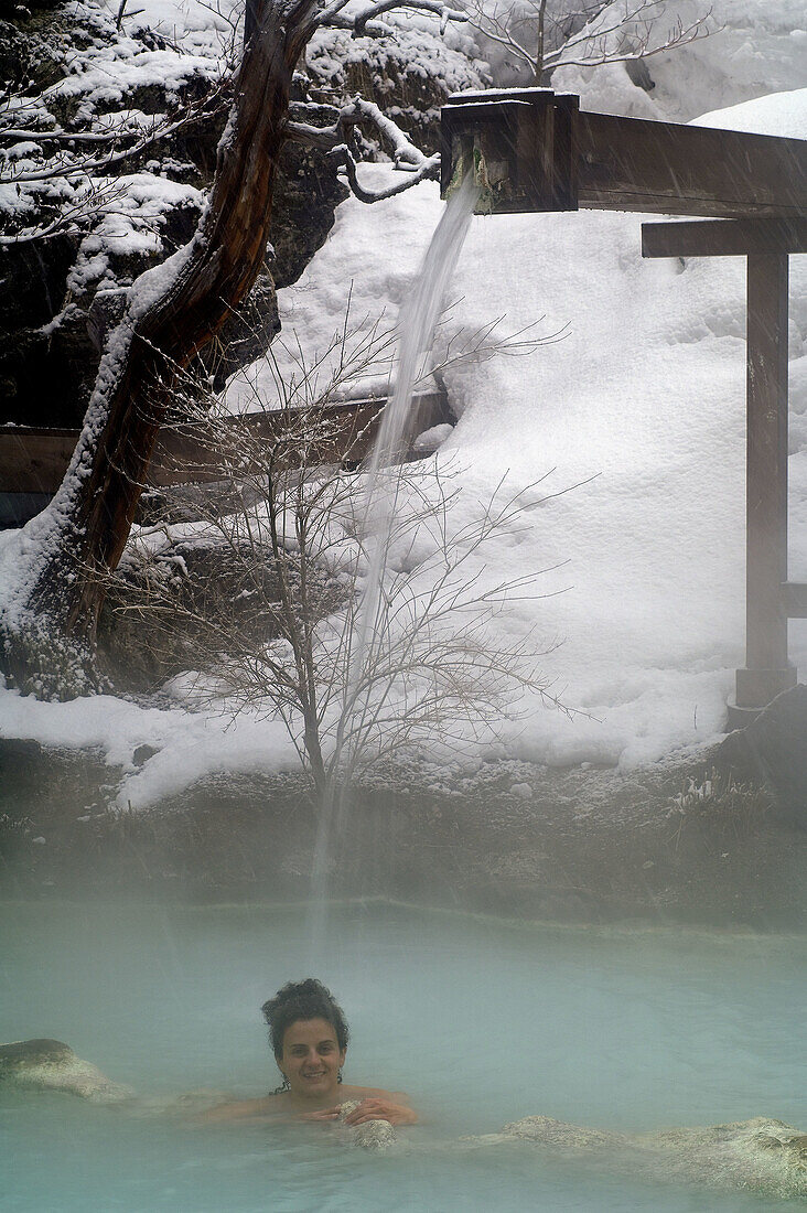 A woman have a bath in an open air hotspring. Awanoyu onsen. Shiraone-onsen azumi. Matsumoto. Nagano prefecture. Chubu Region. Japan