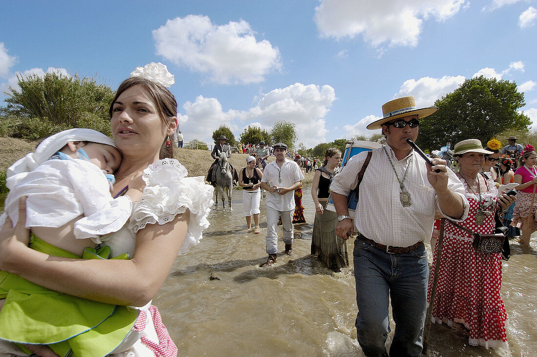 Hermandad de Fuengirola pilgrims to El Rocío crossing Quema River. Huelva province, Andalusia, Spain