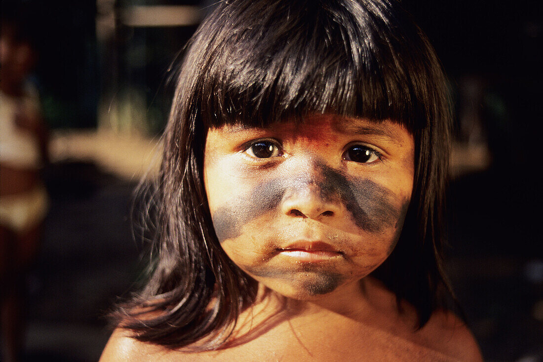 Sateré-Maué girl in the Amazon region gazes curiously into the camera.