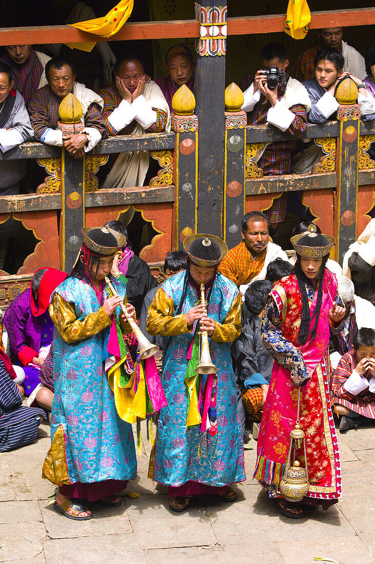 Musicians play horns, Paro Tsechu (festival), Paro Dzong, Paro, Bhutan